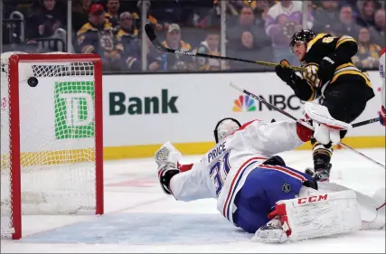  ?? The Canadian Press ?? Boston Bruins’ David Pastrnak scores against Montreal Canadiens goaltender Carey Price in Boston on Feb. 12.