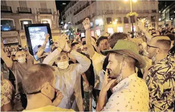  ??  ?? PEOPLE celebrate as the state of emergency decreed by the Spanish Government to prevent the spread of Covid-19 gets lifted at Puerta del Sol square in Madrid, Spain, yesterday. | Reuters