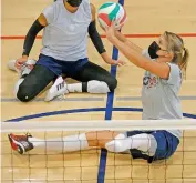  ?? —
AP ?? Lora Webster (right) with the US women’s sitting volleyball team sets the ball during practice in Edmond, Oklahoma, in this photo taken in July this year.