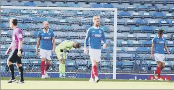  ??  ?? SINKING FEELING
The disappoint­ment shows after Pompey fall behind against Wigan Athletic.