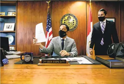  ?? SAM HODGSON U-T ?? San Diego Mayor Todd Gloria looks over talking points Friday with aide Nick Serrano in his City Hall office. “We’ve made progress during my first 100 days, but this is just the beginning,” Gloria said on Thursday. Today is his 100th day in office.