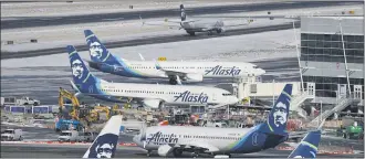  ?? TED S. WARREN ?? Alaska Airlines said over 300 employees among the company’s workforce in Anchorage may lose their jobs on Oct. 1, 2020. The company said the Anchorage layoffs are part of company-wide job cuts because of the economic fallout from the coronaviru­s pandemic, Alaska Public Media reported Tuesday, Aug. 4.