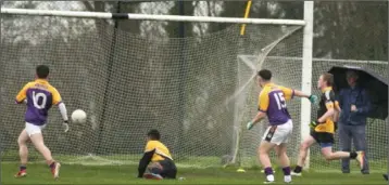  ??  ?? Ashley Tully (15) scoring one of his two goals for St. Patrick’s in Saturday’s final in Craanford.