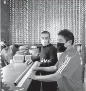  ?? CHRIS SWEDA/CHICAGO TRIBUNE ?? Food runners Ernesto Estrada, left, and Eligio Alejandro wait on orders in the kitchen Tuesday at Avec West Loop in Chicago.