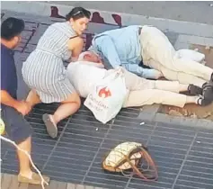  ??  ?? People attend to injured persons at the scene. — Reuters photos