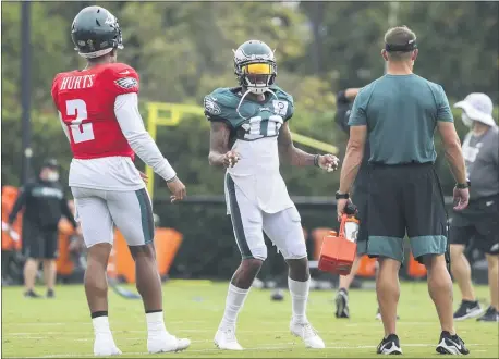  ?? POOIL PHOTO - MONICA HERNDON/THE INQUIRER ?? Eagles wide receiver DeSean Jackson, center, and quarterbac­k Jalen Hurts, left, go through a drill during practice Wednesday at the NovaCare Complex.