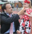  ??  ?? Health Minister Leo Varadkar with Kiya O’Connor (3) from Macken Street, Dublin, at the launch of the online registrati­on system for the new free GP care on Pearse Street. Photo: Damien Eagers