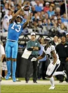  ?? MIKE MCCARN — THE ASSOCIATED PRESS ?? The Carolina Panthers’ Kelvin Benjamin (13) catches a pass as the Philadelph­ia Eagles’ Rasul Douglas (32) defends in the first half of an NFL football game in Charlotte, N.C., Thursday.