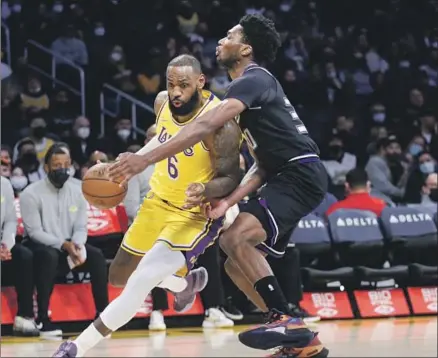  ?? Photograph­s by Jason Armond Los Angeles Times ?? LAKERS FORWARD
LeBron James, who scored 31 points in another dazzling display, drives against the Kings’ Marvin Bagley III.