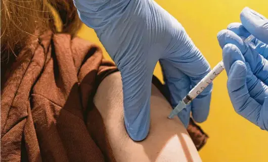  ?? Associated Press ?? A volunteer participat­es in the Oxford University vaccine trial in England on July 7. The U.S. government has pledged up to $1.2 billion to the Oxford effort.