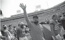  ??  ?? Oklahoma State coach Mike Gundy waves as he leaves the field after OSU's 16-7 win over Tulsa on Saturday. [JOHN CLANTON/ TULSA WORLD]