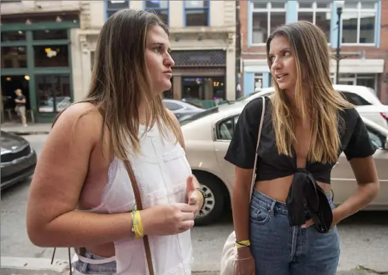  ?? Emily Matthews/Post-Gazette ?? Friends Haylie Medoff, of Los Angeles, left, and Melissa Saunders, who said she lives south of Pittsburgh, talk about the increase in shootings on the South Side on Saturday. One of the incidents on Friday evening claimed the life of a 29-year-old Homestead man.