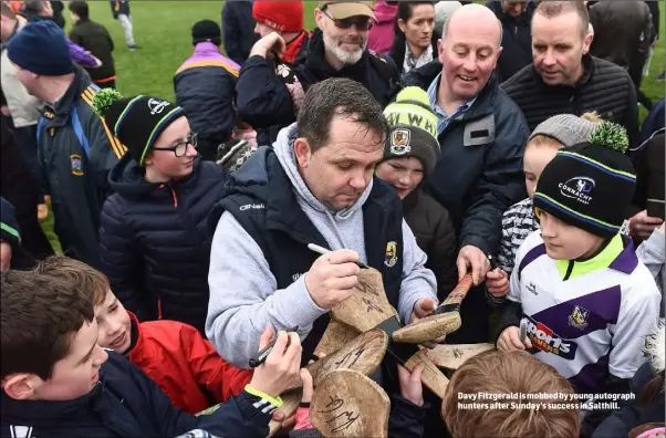  ??  ?? Davy Fitzgerald is mobbed by young autograph hunters after Sunday’s success in Salthill.