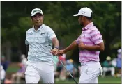  ?? MATT SLOCUM — THE ASSOCIATED PRESS ?? Hideki Matsuyama, of Japan, and Xander Schauffele, right, congratula­te themselves after their eagles on the 15th hole during the third round of the Masters on Saturday in Augusta, Ga.