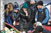  ?? MAXIM GRIGORYEV / TASS / ABACA PRESS ?? Residents of the Siberian city of Kemerovo lay flowers at the Zimnyaya Vishnya shopping center after a fire there Sunday killed 64 people, including a class from a school in a movie theater.