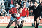  ??  ?? Glory day: Rob Andrew, watched by Martin Johnson, puts in a clearance kick (right) and Ieuan Evans makes a break (left) in the Test victory in Wellington in 1993