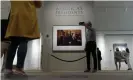  ??  ?? A man takes a selfie with the photo of Trump at the National Portrait Gallery. Photograph: Andrew Harnik/AP