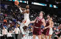  ?? Charlie Neibergall/Associated Press ?? Texas guard Marcus Carr, left, drives to the basket past Colgate guard Tucker Richardson in the second half.