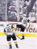  ?? TREVOR HAGEN/THE CANADIAN PRESS VIA AP ?? Vegas’ Tomas Tatar (90) celebrates with Pierre-Edouard Bellemare after Tatar scored in the Golden Knights’ win over Winnipeg Monday.