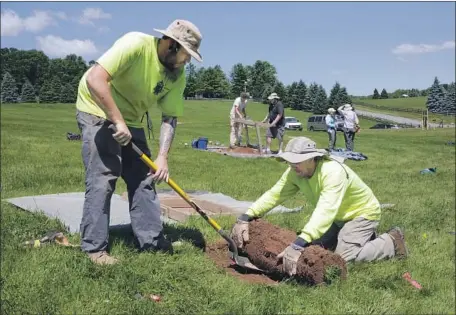  ?? Photograph­s by Richard Drew Associated Press ?? JESSE PAGELS, left, and Edgar Alarcon of Binghamton University’s archaeolog­y team dig at the site of Woodstock in Bethel, N.Y.