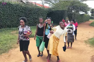  ?? VALERIE FORTNEY ?? Girls and young women leave classes at the Yatta location of Mully Children’s Family in Kenya.