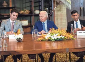  ?? DOUG MILLS/AP ?? Biden talks Wednesday with Canadian Prime Minister Justin Trudeau, left, and British Prime Minister Rishi Sunak in Bali, Indonesia.