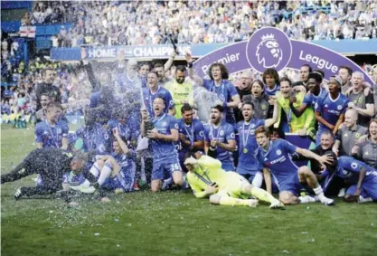  ??  ?? LONDON: The Chelsea team including captain John Terry, 26, celebrate after they won the league, following the English Premier League soccer match between Chelsea and Sunderland at Stamford Bridge stadium. — AP