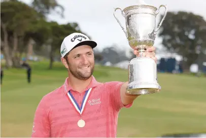  ?? Picture: AFP ?? ALL MINE. Spain’s Jon Rahm celebrates with the trophy after winning the US Open at Torrey Pines Golf Course in San Diego on Sunday.