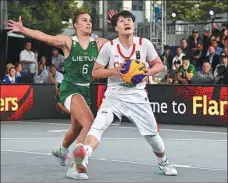  ?? AFP ?? China’s Wan Jiyuan eyes a basket attempt as Lithuania’s Kamile Nacickaite defends during the women’s bronze-medal match at the FIBA 3x3 World Cup in Antwerp, Belgium, on Sunday.