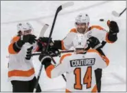  ?? DARRYL WEBB — THE ASSOCIATED PRESS ?? The Philadelph­ia Flyers’ Travis Konecny (11) and Claude Giroux (28) congratula­te Sean Couturier (14) after he scored against the Arizona Coyotes during Monday’s game in Glendale, Ariz.