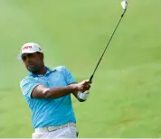  ?? — AFP ?? Anirban Lahiri of India hits the ball on the 10th fairway during the first round of the 2017 CIMB Classic golf tournament in Kuala Lumpur on Thursday.