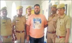  ?? HT PHOTO ?? Illicit liquor trade mastermind Vijay Kumar Sindhi alias Viju (in orange t-shirt) in the custody of Dungarpur police. He was sent to judicial custody on Thursday