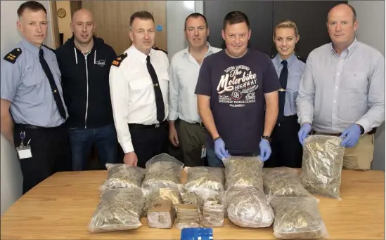  ??  ?? LEFT: Local gardaí Geoff Scally, Stephen Burke, Superinten­dant Jim Doyle, Colm Dunne, Leonard Casey, Jenny Desmond and Matt Kelly with the cannabis and cocaine haul worth nearly €300,000 following Saturday’s seizure at a house in Carne.