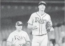  ?? FRED THORNHILL THE CANADIAN PRESS ?? Tampa Bay Rays pitcher Tyler Glasnow waits on the mound for his manager after giving up six runs to the the Blue Jays in the first inning of their American League baseball game in Toronto on Wednesday. Toronto won the game, 10-3. For complete coverage, see therecord.com.