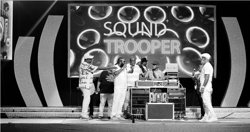  ?? ?? Sound Trooper cues the next rhythm as entertaine­rs hold a reasoning onstage at the Original Dancehall Style stage show in 2022.