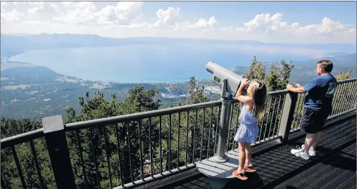  ?? AP PHOTO/RICH PEDRONCELL­I ?? In this photo taken Tuesday, Aug. 8, 2017, Lilyana Allen, of Guam, uses a telescope to view Lake Tahoe from an observatio­n platform at the Heavenly Mountain Resort during a family visit to South Lake Tahoe, Calif.