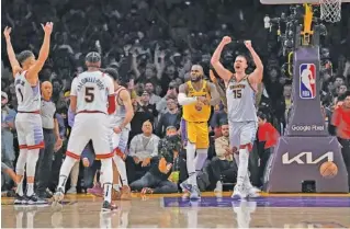  ?? AP PHOTO/ASHLEY LANDIS ?? Denver Nuggets center Nikola Jokic (15) celebrates after Los Angeles Lakers forward LeBron James, center, missed a layup attempt as time expired in the second half of Game 4 of the NBA Western Conference Final series on May 22 in Los Angeles. Denver won 113-111 to win the series.