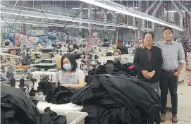  ?? PHOTOS: SUPPLIED ?? Andy Vu, right, with his father Phong Vu, in the Calgary plant where King Athletics’ Canadian-made clothing is assembled. The company employs 35 people in Calgary.