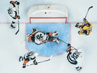  ?? MATT SLOCUM/AP PHOTOS ?? The Penguins’ Josh Archibald, right, scores a goal past Flyers goalie Carter Hart on Friday.