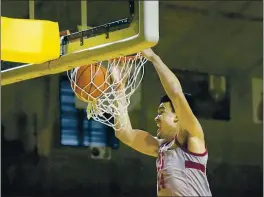  ?? PHOTOS BY TONY AVELAR — THE ASSOCIATED PRESS ?? Stanford forward Spencer Jones dunks against UCLA during the first half in Santa Cruz on Saturday.