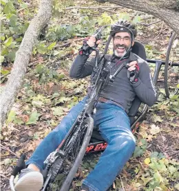  ?? NEIL STANTON ?? Todd Balf pedals beneath a storm-tossed tree on a cycling route.