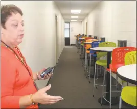  ??  ?? Evelyn Arnold, principal at the Robert D. Stethem Educationa­l Center, shows the cafe area at the new Virtual Academy.