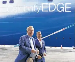  ?? MARTA LAVANDIER/AP ?? Richard Fain, left, chairman and CEO of Royal Caribbean Group, and Brian Abel, senior vice president of hotel operations and Celebrity Cruises, walk next to the Celebrity Edge in June in Fort Lauderdale.