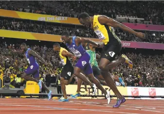  ?? Kirill Kudryavtse­v / AFP / Getty Images ?? Jamaica’s Usain Bolt (right) lunges at the finsh line but is beaten in the 100-meter final by two Americans, Justin Gatlin (far left) and Christian Coleman (next to Bolt).