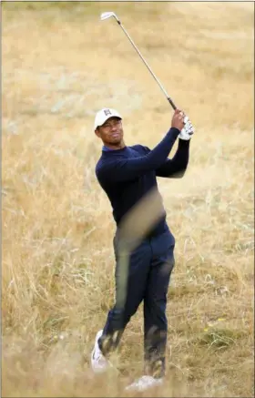  ?? PETER MORRISON — ASSOCIATED PRESS ?? Tiger Woods plays out of the rough on the second hole during a practice round for the 147th British Open on July 17 in Carnoustie, Scotland.