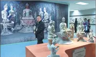  ?? LUO XIAOGUANG / XINHUA ?? Visitors take in the Dunhuang on the Silk Road exhibition in Beijing in April. It featured 3-D printed replicas of Buddha statues from the Mogao Grottoes in Dunhuang, Gansu province.