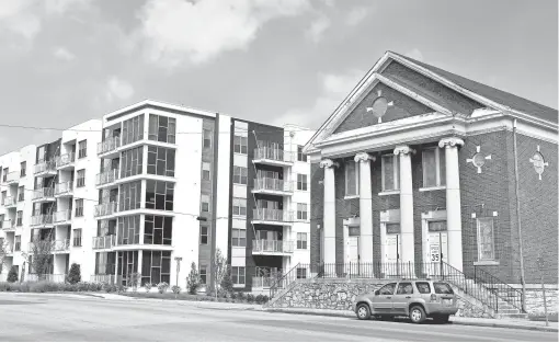  ?? LARRY MCCORMACK, THE TENNESSEAN ?? First Baptist Church East Nashville is in a time of transition because the neighborho­od has changed, and it’s trying to reach new residents. Next door is a high- rise apartment building; behind is Section 8 housing.