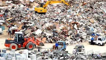  ??  ?? Local residents pile up household waste, caused by a flooding, at a temporary waste-collection point at Mabi Clean Center in Kurashiki, Okayama Prefecture. — Reuters photo