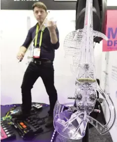  ??  ?? Laurent Bernadac gives a demonstrat­ion on the 3Dvarius electric violin during the 2017 Consumer Electronic Show (CES) in Las Vegas, Nevada on January 5, 2017.