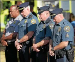  ?? PETE BANNAN – DIGITAL FIRST MEDIA ?? Coatesvill­e-area police officers bow their heads at 9:59 a.m., the moment the South Tower of the World Trade Center collapsed on Sept. 11, 2001. The National Iron & Steel Heritage Museum held a “Coatesvill­e Remembers September 11th“commemorat­ive...